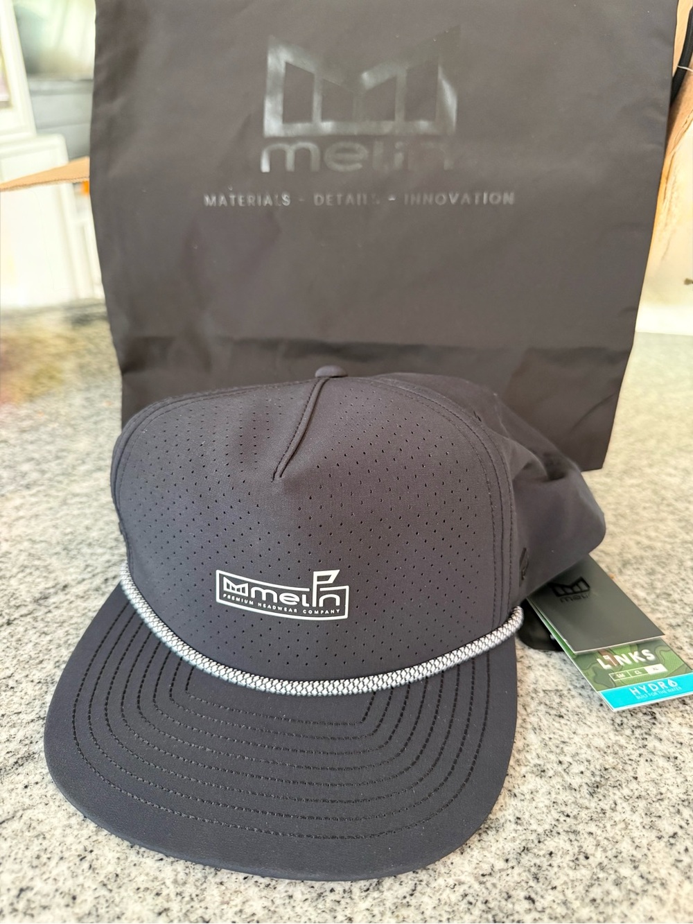 Melin Men's Black Coronado Links Hydro Cap XL